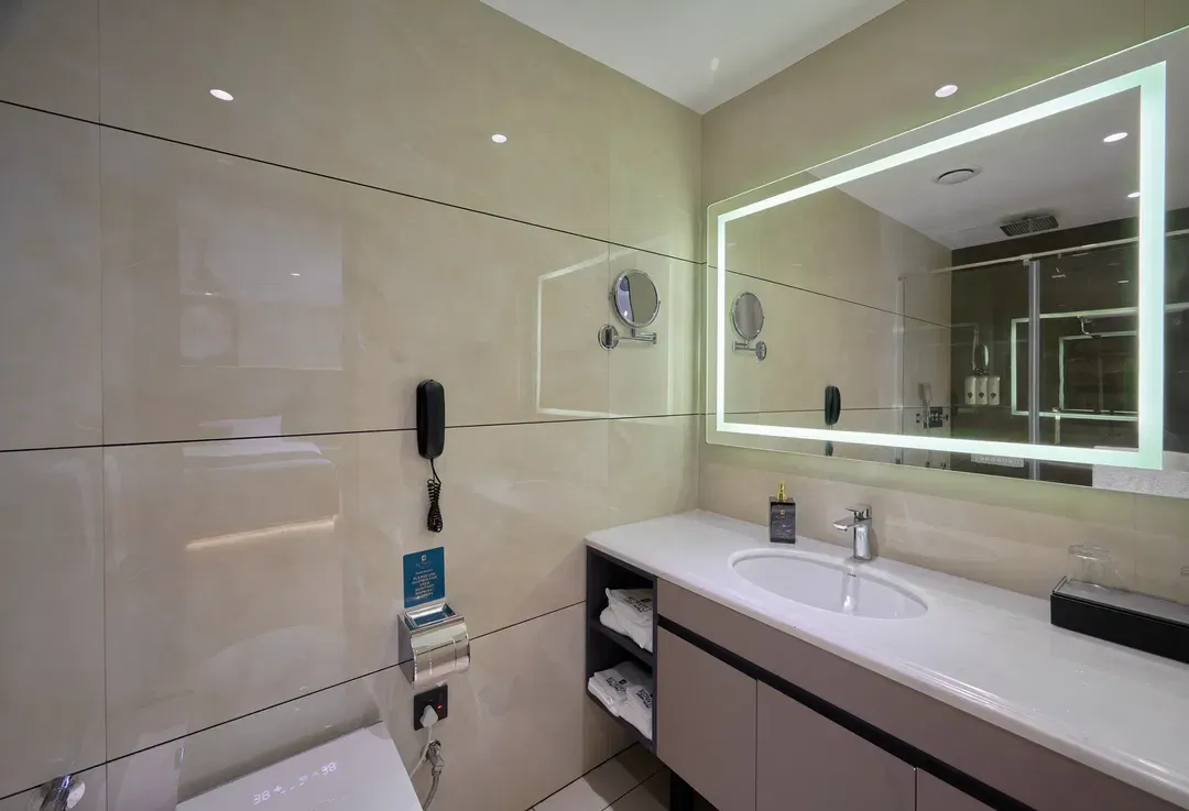 Deluxe King room corner view with window curtains