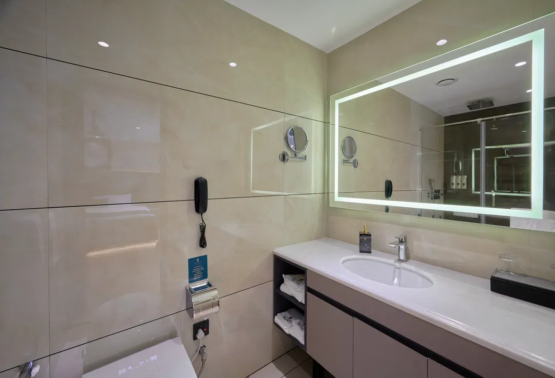 Deluxe King room corner view with window curtains